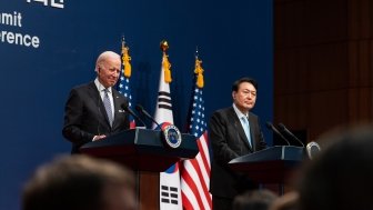 President Biden and President Yoon standing at two adjacent podiums with U.S. and ROK flags in the background.