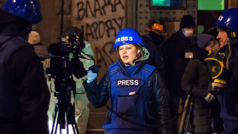 Press in blue body armor in Kyiv during protests.