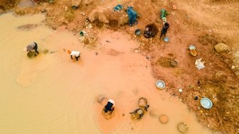 Kunsu, Ghana, March 20, 2023: Rural Women in Small Scale Mining (Galamsey) in Ghana, Africa. The quest for the daily meal of these women relies on them finding gold in an already mined land.