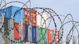 Shipping Containers behind Razor Wire