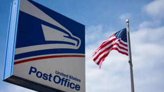 US Post Office Sign With American Flag in the Background