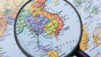 Magnifying glass over map of South East Asia