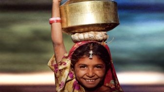 Young girl holding water container in Asia 