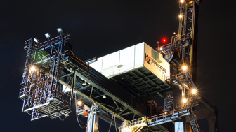 Dutch Harbor, Unalaska, Alaska, USA - August 14th, 2017: Night view of a port crane for shipping containers operated by Horizon Lines located at the port of Unalaska, Alaska