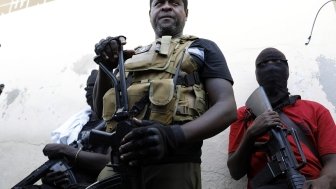 Barbecue, the leader of the "G9 and Family" gang, stands with his fellow gang members after speaking to journalists in the Delmas 6 neighborhood of Port-au-Prince in Port-au-Prince, Haiti, Tuesday, March 5, 2024. 