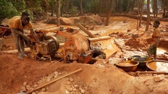 Assafo, Ivory Coast - April 3, 2024: children feeding a crusher with ore to extract some grams of gold. In Ivory Coast, children from Burkina Faso often provide cheap manpower for local businessmen