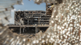 Wide angle view of Donetsk airport ruins through broken glass after massive artillery shelling.