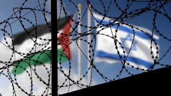 Flags of Israel and Palestine and barbed wire