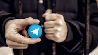 Man Holding Telegram logo