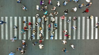 Aerial view of pedestrians passing a crosswalk during rush hour