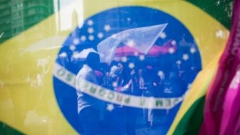 Brazilian Flag with Protest behind