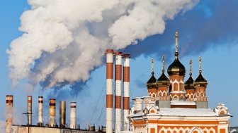 Smoking chimneys over blue sky