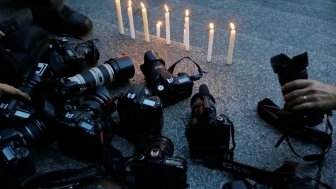 Cameras at a candlelight vigil