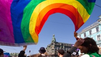 Saint-Petersburg, Russia - May 01, 2019: May demonstration. Marchers with a rainbow LGBT flag on Nevsky prospect.