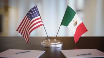 USA and Mexican flags on table