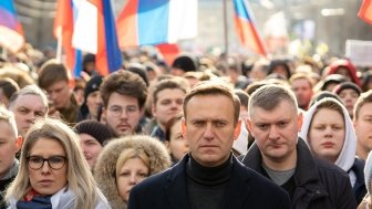 Lyubov Sobol abd Alexei Navalny on march in memory of Boris Nemtsov. People, flag and poster on the background, February 2020.