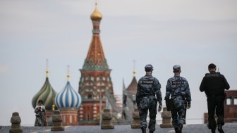 Russian police officers walk across Red Square.