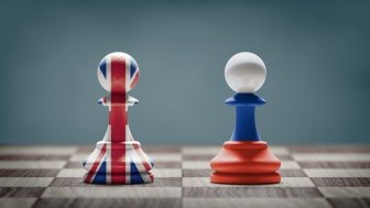 UK and Russia conflict. Country flags on chess pawns on a chess board. 3D illustration.