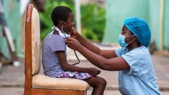 African doctor treating a child