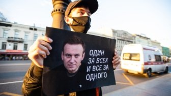 Person pickets in support of Alexei Navalny following his August 2020 poisoning. Sign reads "One for all and all for one"