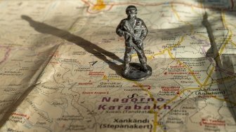 A figure soldier standing on a map of Nagorno-Karabakh