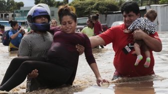 A pregnant woman is carried out of an area flooded by water brought by Hurricane Eta in Planeta, Honduras, Nov. 5, 2020.