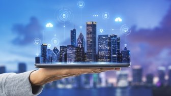 Smart city technologies concept with digital tablet and night megapolis city skyscrapers with digital cloud icons on human hand at blurry skyline background