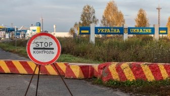 Control sign and concrete blocks at the entrance to the Ukrainian checkpoint from Russia