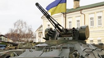 Army troops transporter and tank with Ukrainian flag, Ukraine