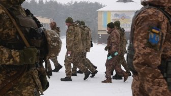 Kharkiv, Ukraine - January, 31, 2022: Many Ukrainian soldiers in camouflage uniforms march in formation. Ukrainian army prepares for Russian invasion