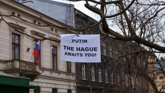 Sign that reads: "Putin the Hague Awaits you!" 