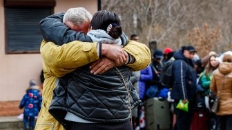 Ukrainian refugees embrace