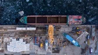 Aerial view from above of the river port with gantry cranes. Cranes in the cargo port of Togliatti in winter.