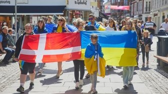 Marchers hold Ukrainian and Danish flags