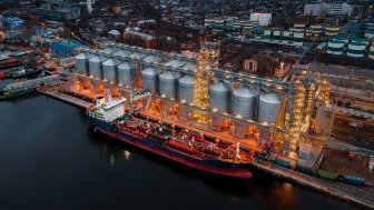 Ship at port next to large grain elevators