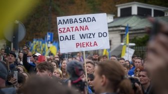 A man in Warsaw, Poland holds a sign protesting the Russian invasion of Ukraine