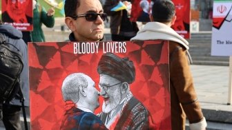 Kyiv, Ukraine - 28 October 2022: Iranian man with political banner in hands protests against dictatorship and ayatollah regime in Iran at street rally. reportage editorial photo