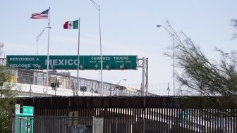 View of the U.S.-Mexico Border Wall with the Mexico border checkpoint on the Bridge of the Americas International Bridge in the background