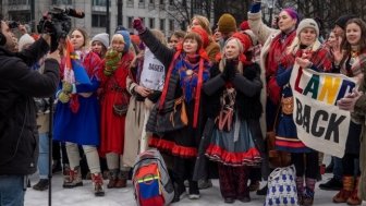 The Sami people, and others, holding a demonstration against the government because of the windmills being built on their land.