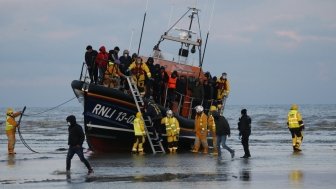 Migrants brought ashore after being rescued at sea by RNLI after travelling across the English Channel. 