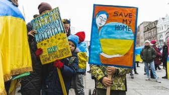 Protesters with signs against the Russian invasion