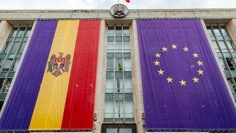 Large flags of Moldova and the European Union on the building of the government of Moldova on the eve of the summit of the European Political Community