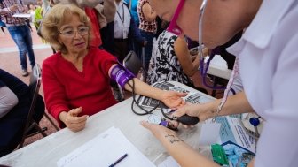 ypertension in Older Age. Young Female Medical Worker Measuring Blood Pressure, Patient.