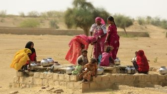 Women drawing water from a well