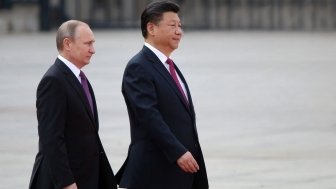 Russian President Vladimir Putin and Chinese President Xi Jinping walking side by side