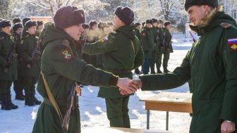 young soldier shakes hand of military recruitment officer