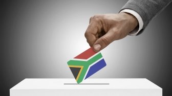 Man Casting Ballot with South Africa Flag