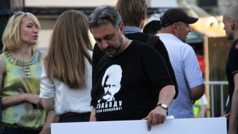 Man holding sign with shirt supporting  Ales Bialiatski