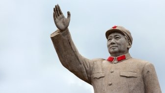 LIJIANG, CHINA, MARCH 8, 2012: Statue of Mao Zedong in central Lijiang. The city is famous for its UNESCO Heritage Site, the Old Town of Lijiang.