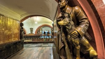 A Soviet border guard and his dog (1938) at the Revolution Square subway station in Moscow.